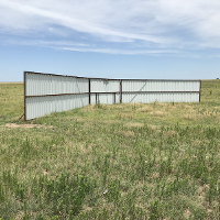 A windbreak made a panels in a pasture