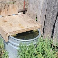 A wooden cover over a watering tank