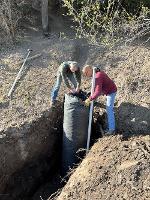 A team works to install the components of a wet well.