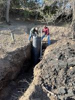 A team works to install the components of a wet well.