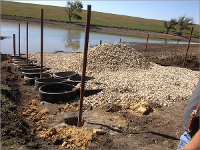 a view of the construction of a limited access ramp for a pond