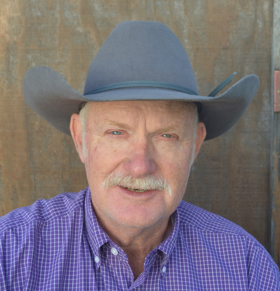 Jeff Davidson, wearing a hat, smiles at the camera