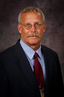 Jeff Davidson, wearing a hat, smiles at the camera