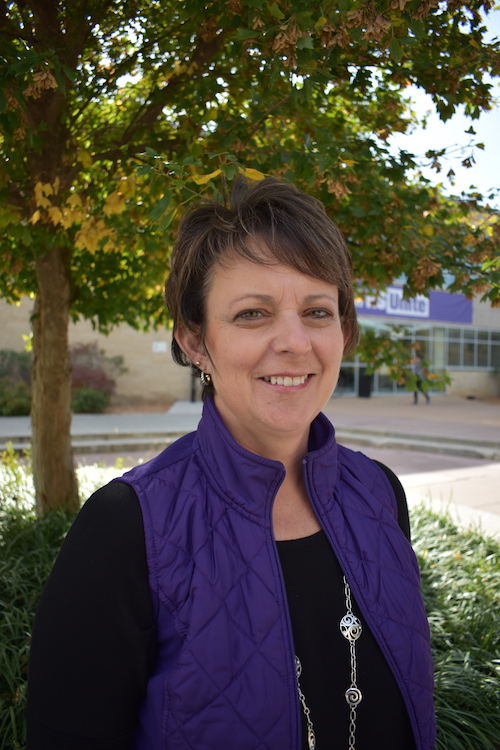Stacie Minson poses for a photograph in front of K-State Student Union.