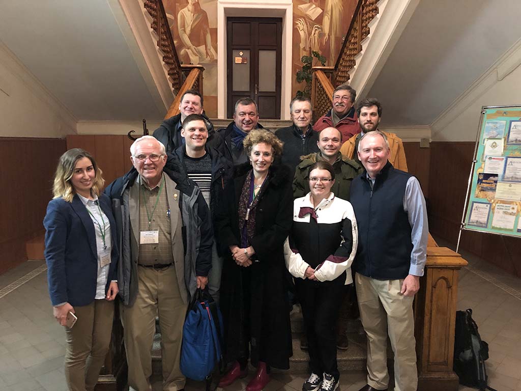 Group of scientists pose with Dr. Dan Devlin