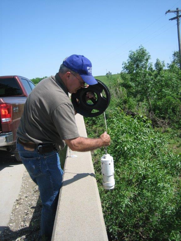 man takes water samples