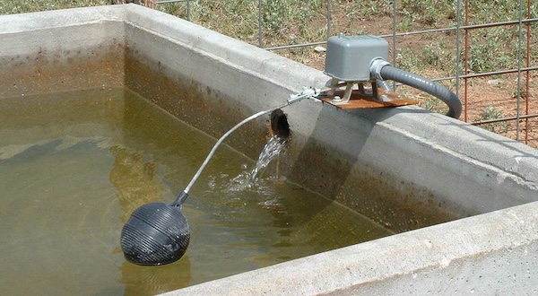 a concrete water tank with a water-level gauge